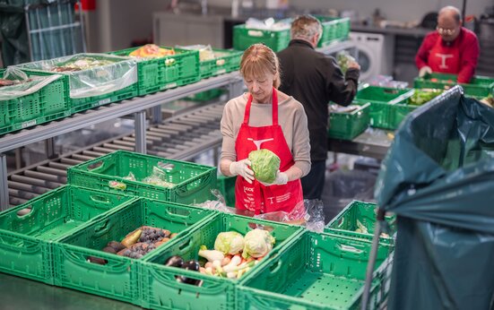 Freiwillige im Einsatz am Logistik-Standort Staufen der Hilfsorganisation Tischlein deck dich stellen gerettete Lebensmittel für die Lebensmittelabgabe zusammen. 