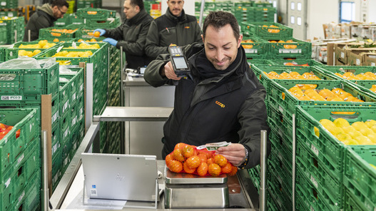 Mitarbeiter im Coop-Hub Novazzano scannt überschüssige Lebensmittel für die Weitergabe an Tischlein deck dich und vermeidet so Food Waste